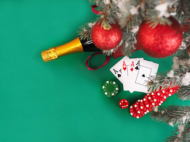 Playing cards and poker chips near a Christmas tree Playing cards and poker chips near a Christmas tree. christmas casino stock pictures, royalty-free photos & images