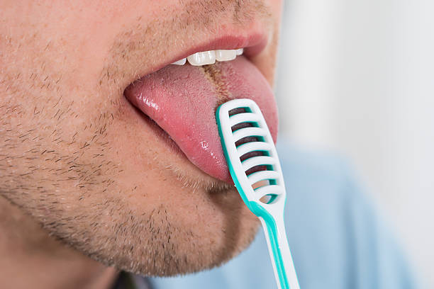 istock Man Cleaning Her Tongue 625874674