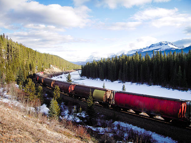 istock Freight Train along Bow River in Winter, Canadian Rockies 625874966