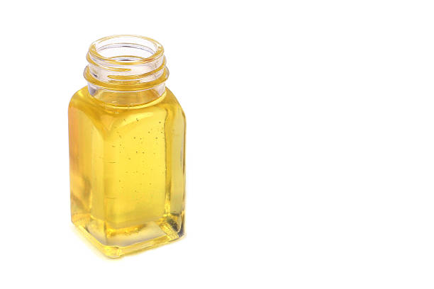 Castor oil in glass bottle on white background Castor oil in glass bottle on white background castor oil stock pictures, royalty-free photos & images