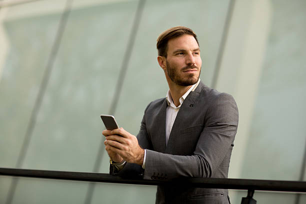 istock Young bisinessman with mobile phone 625875210