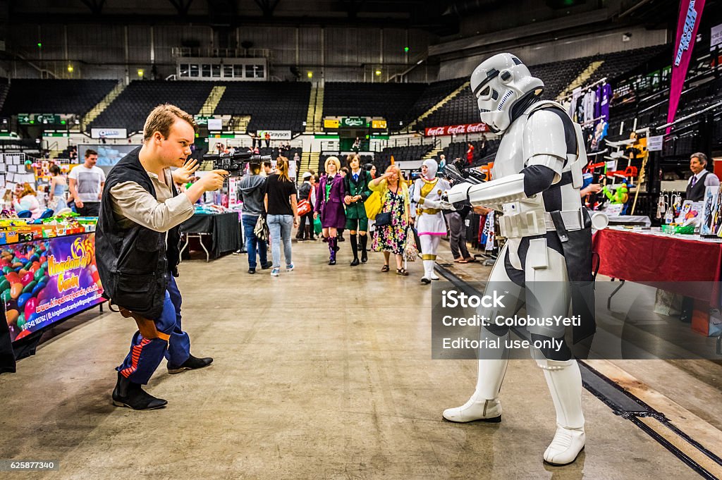 Cosplayers dressed as a 'stormtrooper' and 'Han Solo' Sheffield, United Kingdom - June 12, 2016: Cosplayers dressed as a 'stormtrooper' and 'Han Solo' from 'Star Wars' having a mock fight at the Yorkshire Cosplay Convention at Sheffield Arena Comic-Con Stock Photo
