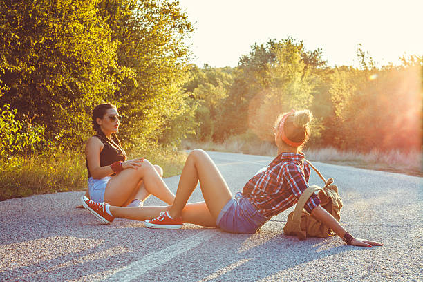 Two best friends sitting on the road