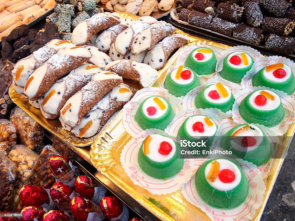 Cannoli and cassate Sicilian food: cannoli and cassate on sale in a street food market. Sicily Stock Photo