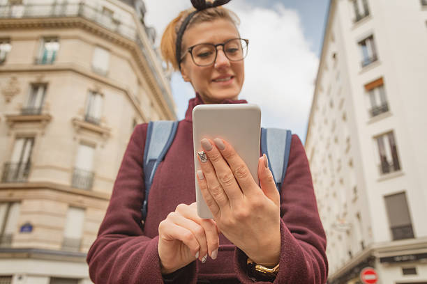 istock Girl using cellphone in urban surroundings. 625878888
