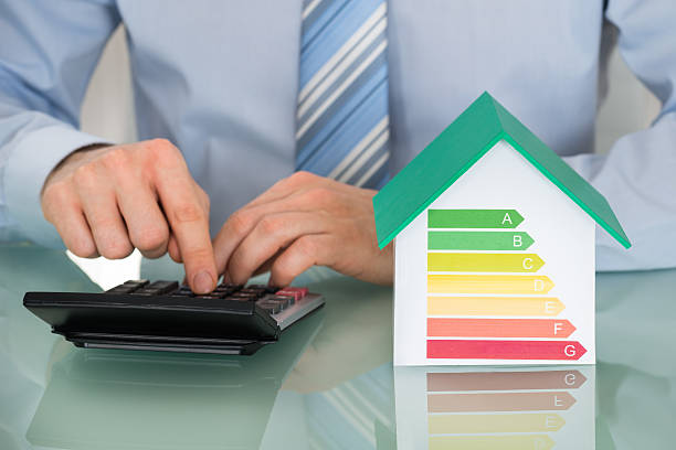 istock Businessman Using Calculator Near House Model 625880546