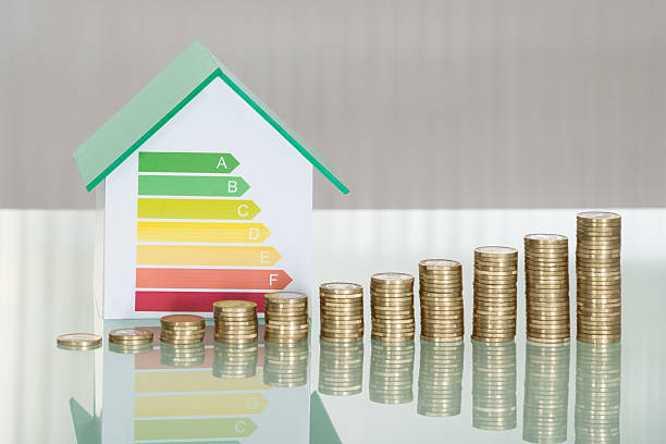 istock Stacked Coins And House Model Showing Energy Efficiency Rate 625880906