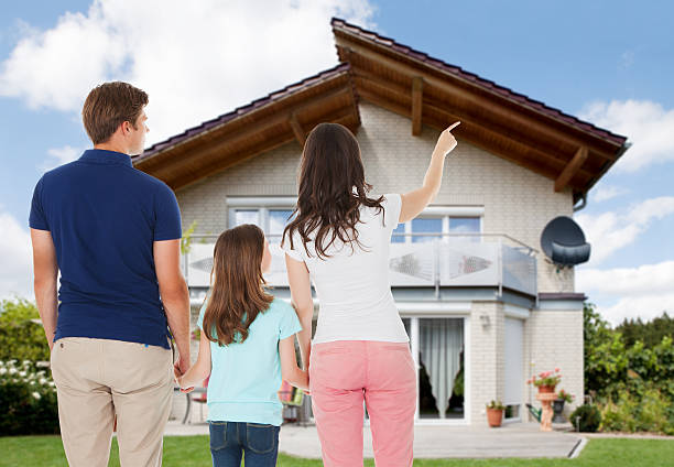 istock Family Standing In Front Of House 625881430