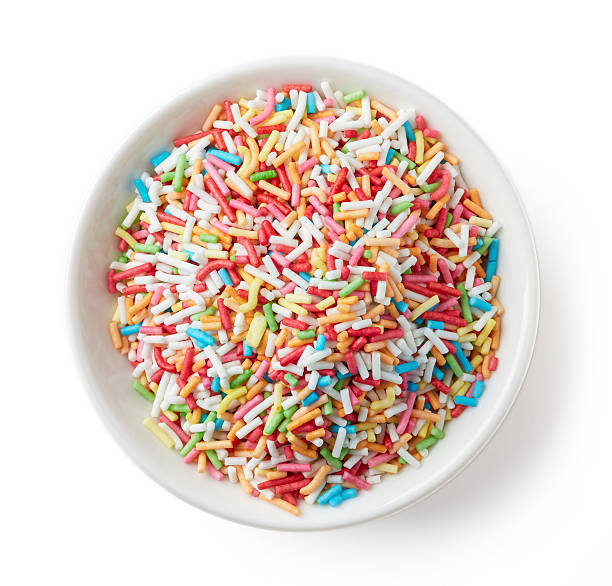 istock Colorful candy sprinkles in white bowl isolated on white 625887048