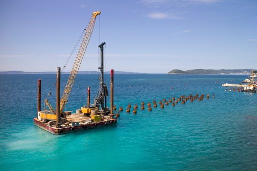Platform with drilling machine building foundations of new jetty in Split harbor in Croatia