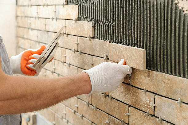 istock Installing the tiles on the wall. 625889124