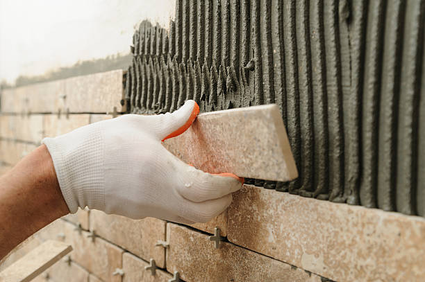 istock Installing the tiles on the wall. 625889250