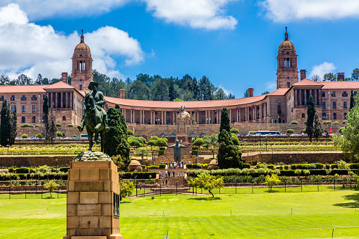 The Union Buildings and gardens in Pretoria, South Africa. This is where parliament is held in South Africa every six months alternatively with Cape Town. Tourists can be seen around Nelson Mandela statue in the centre.