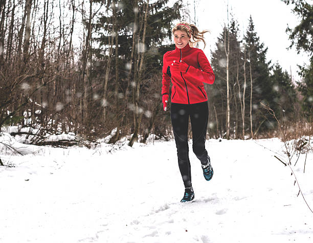 istock Woman running in winter forest 625889546