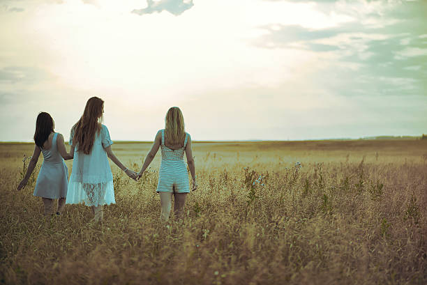 istock Three girls in the field 625889682