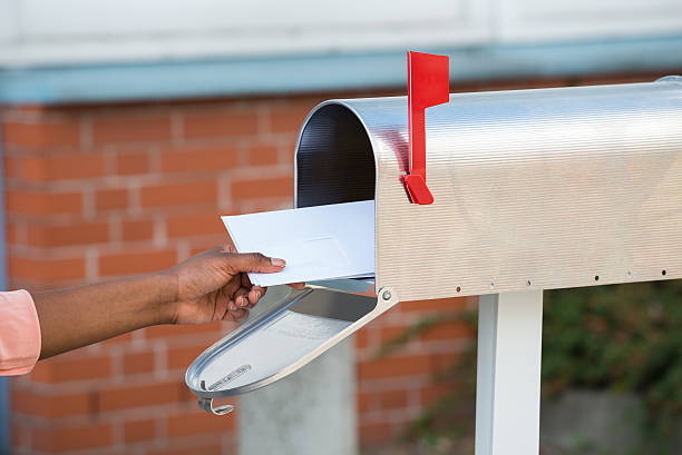 istock Person Putting Letters In Mailbox 625889870