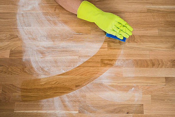 istock Man Cleaning Dust On Wooden Table 625891338