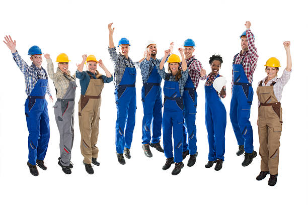 happy carpenters standing with arms raised - manual worker full length isolated on white standing imagens e fotografias de stock