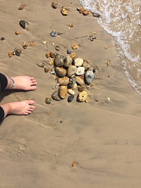 istock Feet on the beach with rocks 625894818