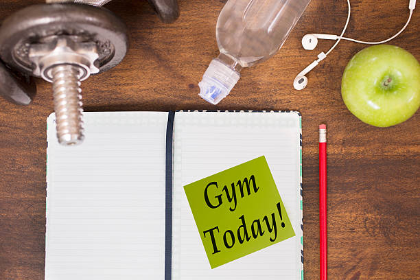 istock Fitness, exercise themed scene with weights, earbuds, apple, calendar. 625895382