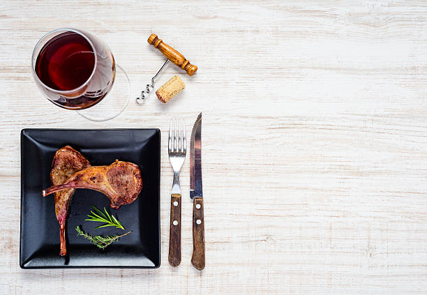 istock Glass Red Wine with Lamb Chops on Copy Space Area 625897038