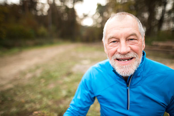 istock Senior runner in nature. Man resting, smiling. Close up. 625902808