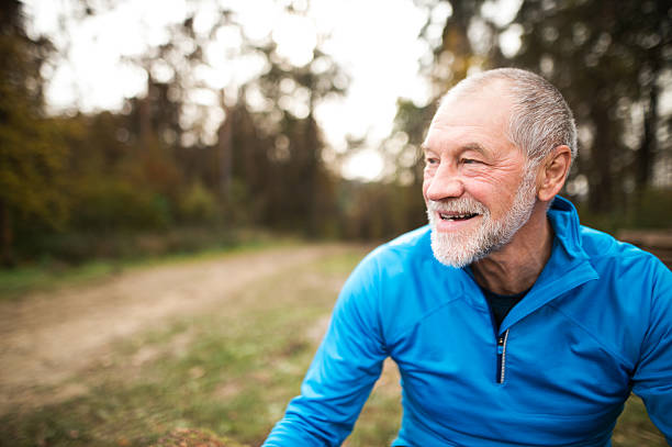 istock Senior runner in nature. Man resting, smiling. Close up. 625903156