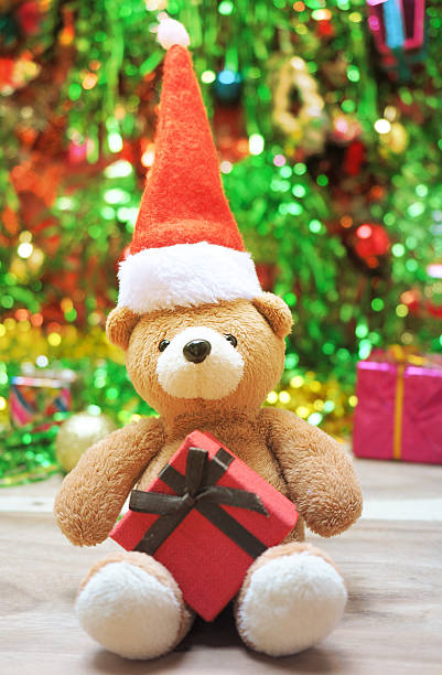 istock Cute teddy bears wearing Santa hats Claus with gift box 625903504