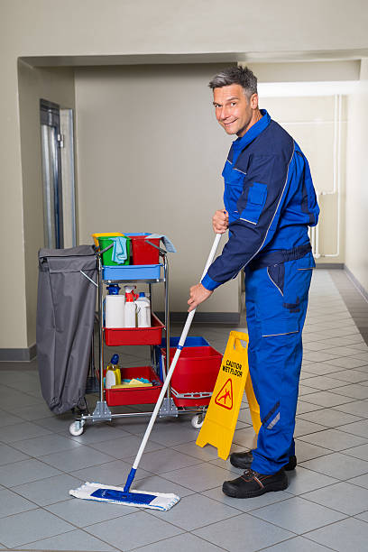 istock Male Worker With Broom Cleaning Corridor 625904028