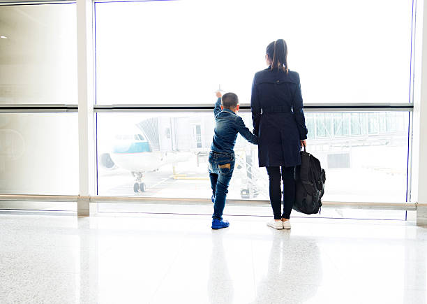 istock Young mother and son at airport 625904724
