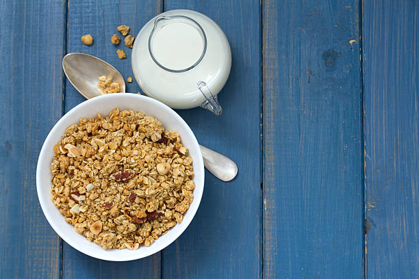 istock granola in white bowl on blue background 625906696