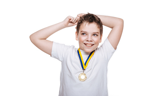 Happy boy with medal on white background.
