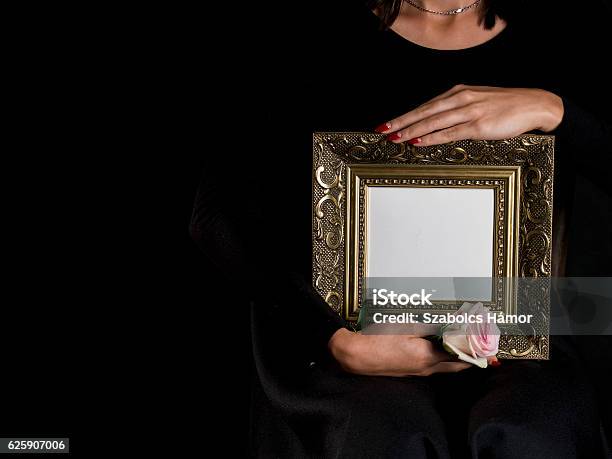 Woman Hold Blank Mourning Frame With Flower Stock Photo - Download Image Now - Adult, Arts Culture and Entertainment, Black Color