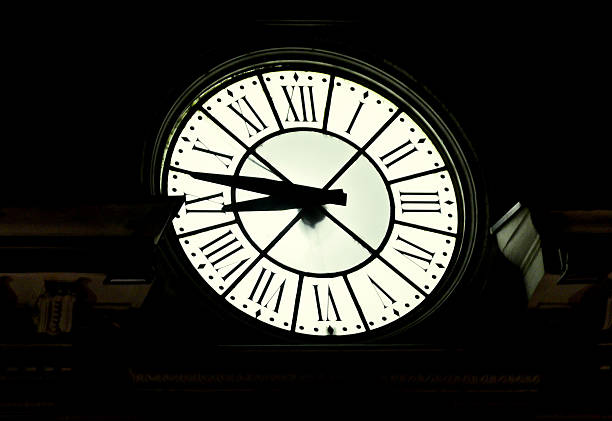 istock Vintage outdoor lighted clock, roman figures, night time 625907262