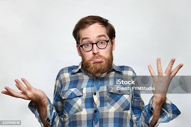 Confused Bearded Man In Eyeglasses Shrugging His Shoulders Stock Photo - Download Image Now