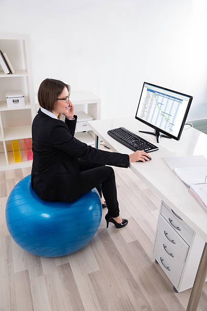 istock Businesswoman Sitting On Pilates Ball Using Computer 625910014