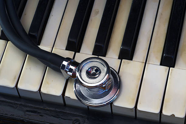 stethoskop auf einer klaviertastatur - stethoscope medical supplies medical instrument medical equipment stock-fotos und bilder