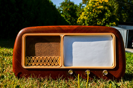 Photo Picture of an Old wooden radio on a grass background