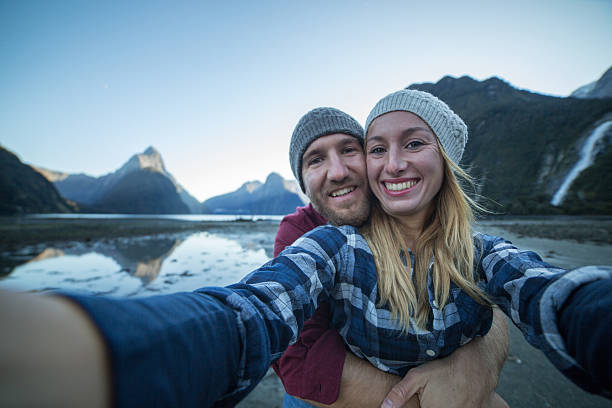 istock Young couple take selfie with mountain lake background 625912552