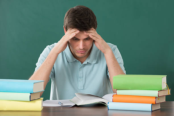istock Man With Books At Desk 625913788