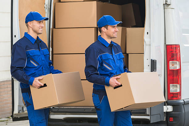 Delivery Men Carrying Cardboard Boxes stock photo