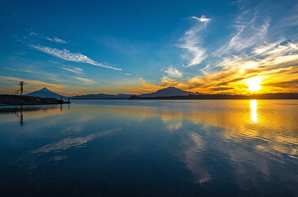 Port Varas The Llanquihue lake at sunrise in the city of Puerto Varas with a view over the Osorno and Calbuco volcano. rio negro province stock pictures, royalty-free photos & images