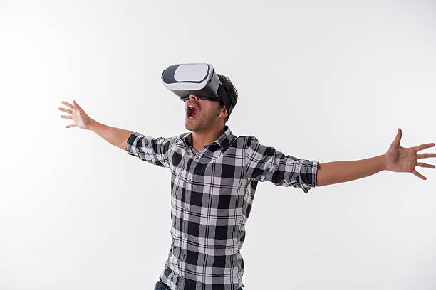 istock young man is surprised by content on VR glasses 625918990