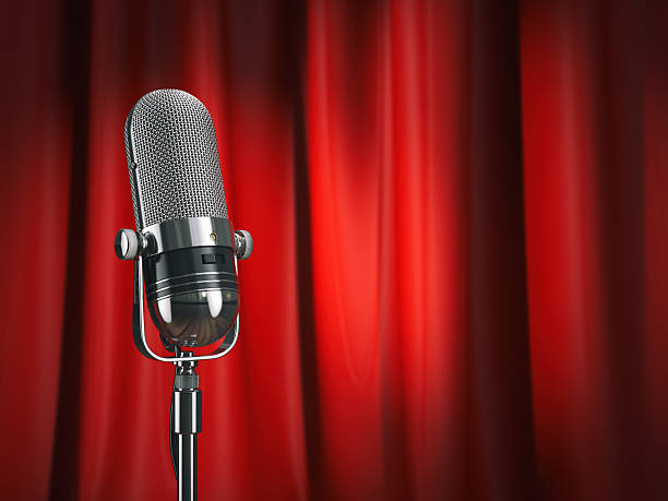 istock Vintage microphone on stage with red curtain. Music concept. 625925498