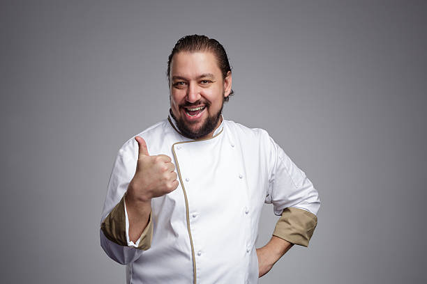istock Pleased chef laughs and shows thumbs up. 625926334