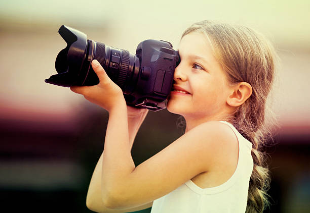 istock girl  holding photo camera 625927944