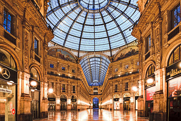 Milan Vittorio Gallery Inside Milan, Italy - July 18, 2013: Shopping mall Galleria Vittorio Emanuele II at sunrise before foot traffic of shoppers and tourists galleria vittorio emanuele ii stock pictures, royalty-free photos & images