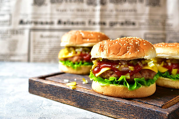 Cheeseburger with meat cutlet and pickled vegetable.