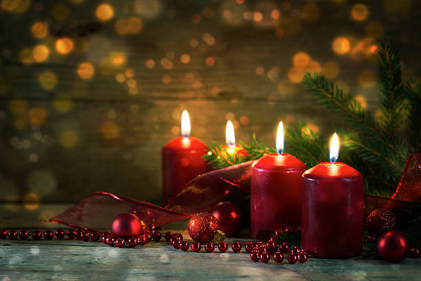 istock red burning advent candles, christmas decoration, rustic wood, bokeh lights 625929180