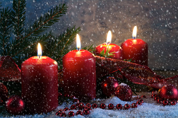 istock red advent candles burning in a snowy night 625929440